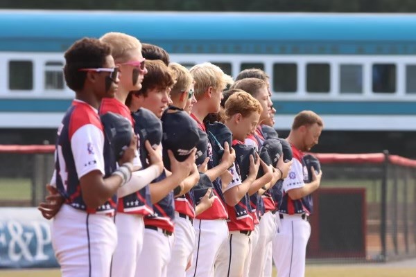 photo of a baseball team lined up for the national anthem at the babe ruth world series
